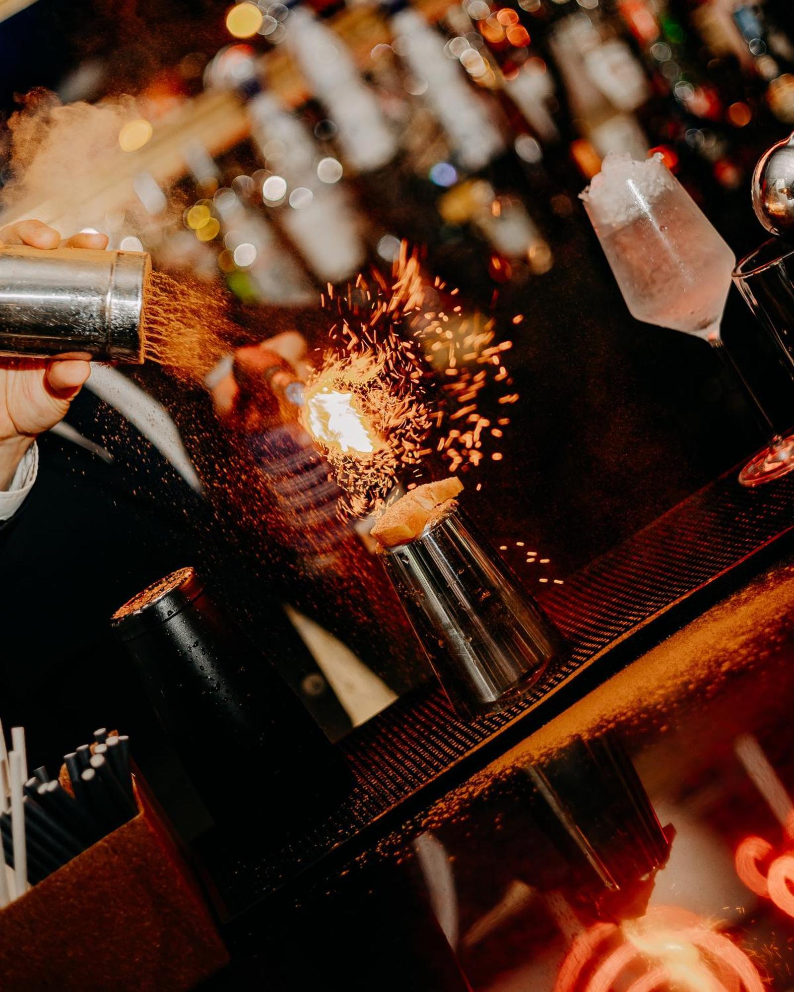 138 Liberdade Hotel Lisbon Bagian luar foto A bartender using a cocktail gun to make a flaming shot